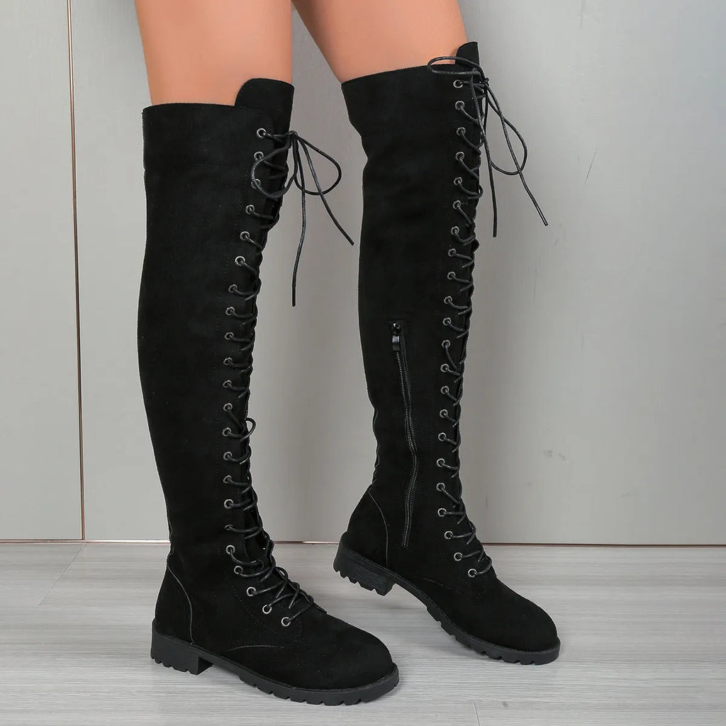 Flat heel round toe lace-up over the knee boots in black, shown with keep warm function and stitching detail.