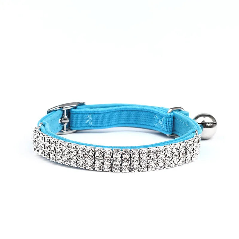 Rhinestone-studded velvet cat collar in assorted colours on a white background