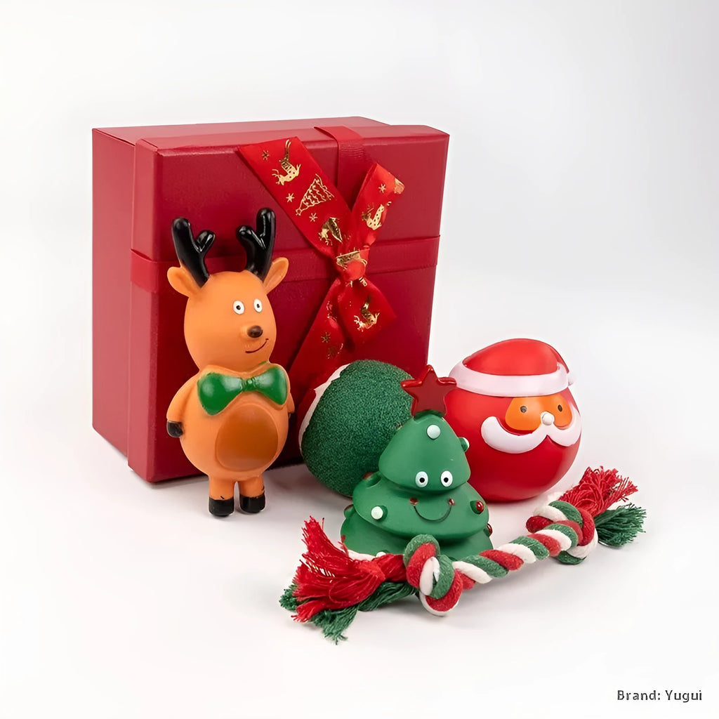 Christmas-themed vinyl dog toys including barbell, ball, rope, and Santa designs in gift packaging