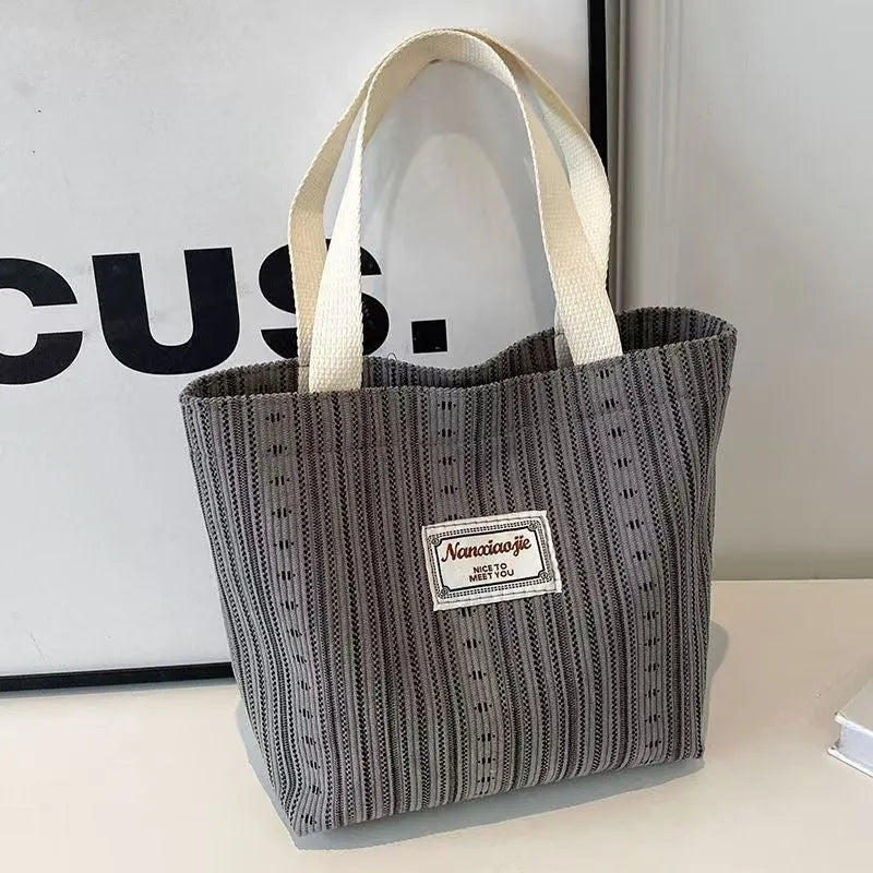 Japanese-style corduroy shoulder bag in dark brown, showing the textured fabric and adjustable strap.