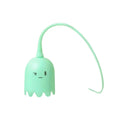 Green automatic cat toy with swinging silicone tails on a white surface