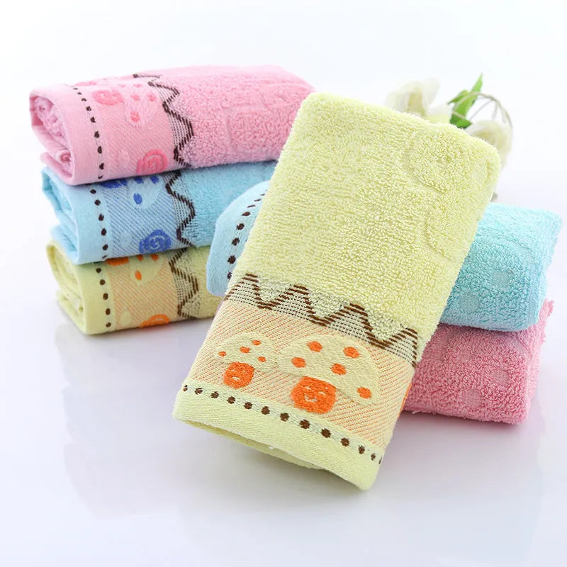 Cotton face towel 73x33cm in blue pink yellow patterns on hanger