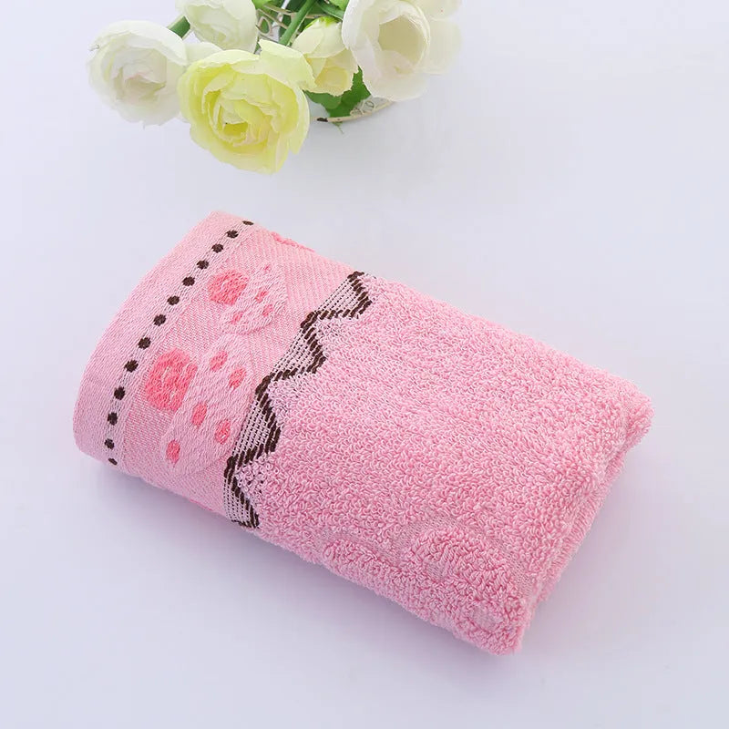 Cotton face towel 73x33cm in blue pink yellow patterns on hanger