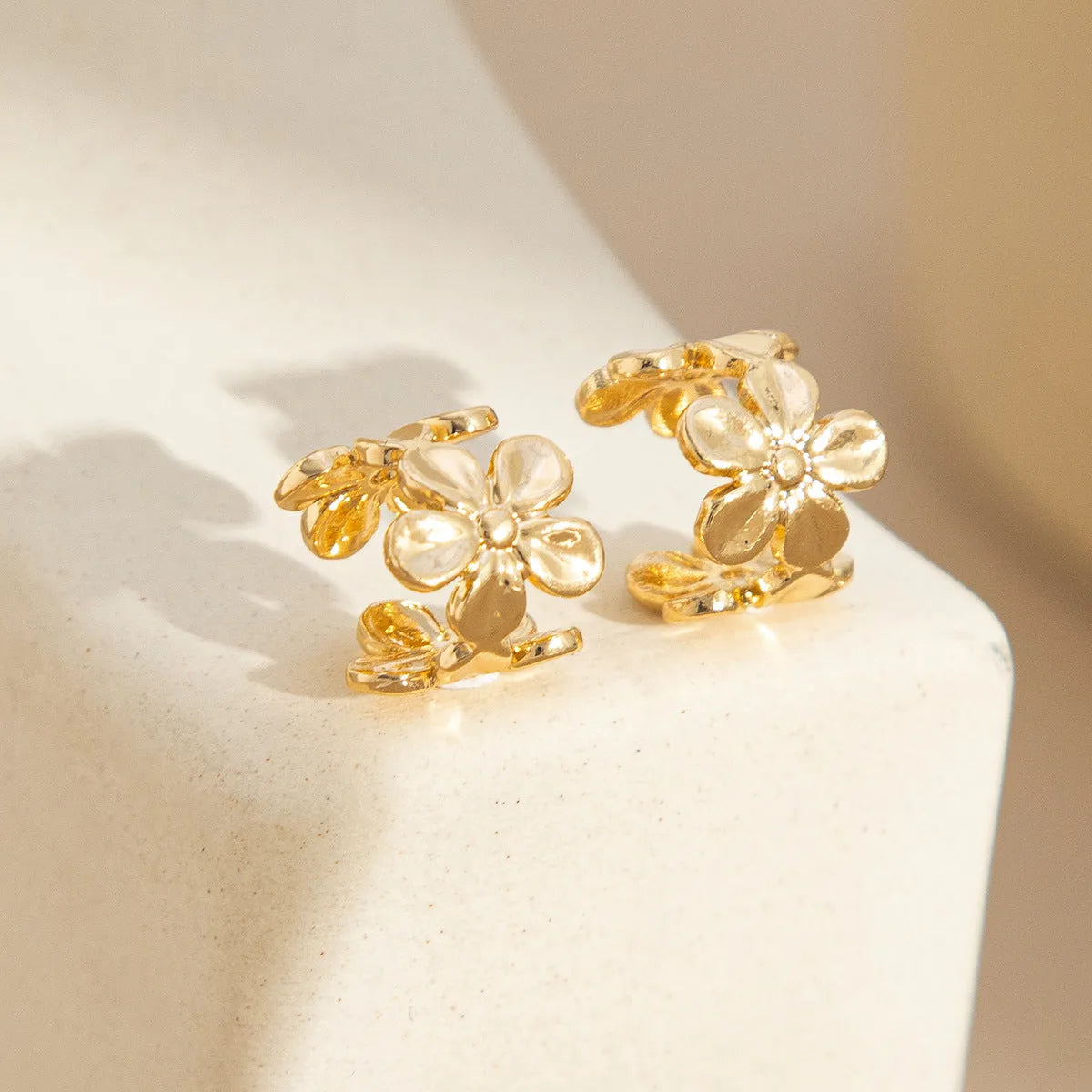 Gold electroplated starfish and conch shell drop earrings with beach style design