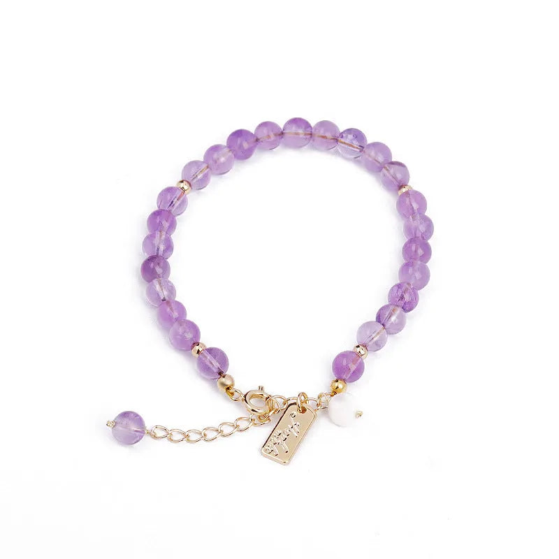 Women's natural lavender amethyst crystal bracelet showing dark and light colour options