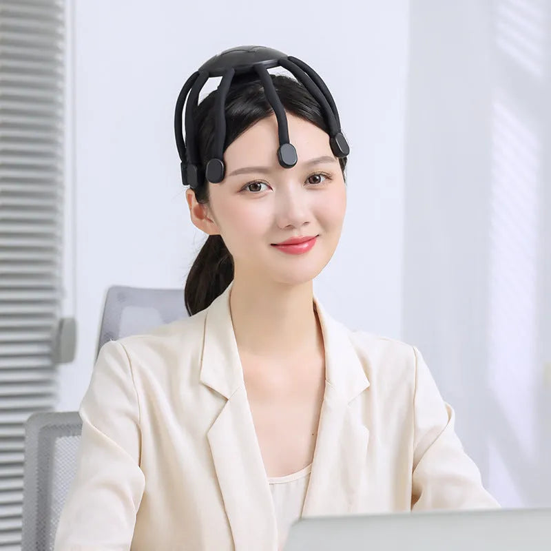 Black and white head massagers with multiple claws and USB cable for charging.