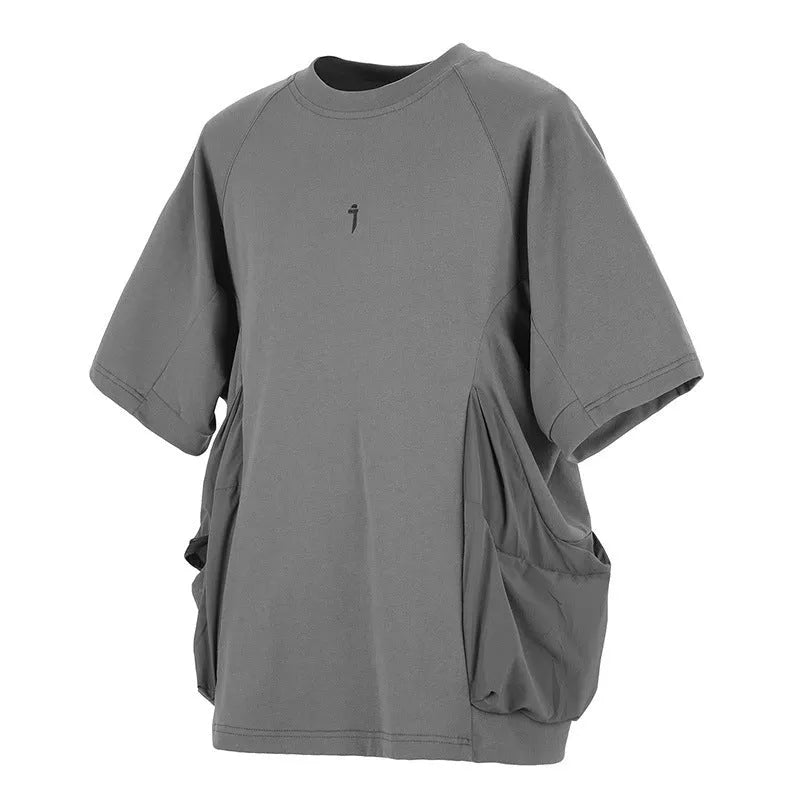 Men's loose grey cotton t-shirt with large chest pockets and short sleeves on a mannequin.