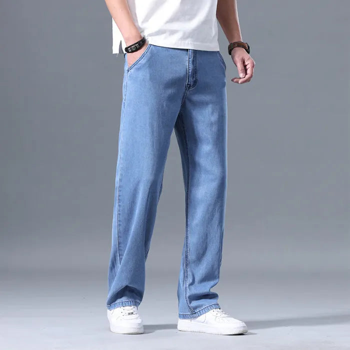 Men's loose straight-leg jeans in a lyocell-blend denim, shown in light blue colour with a zipper fly.