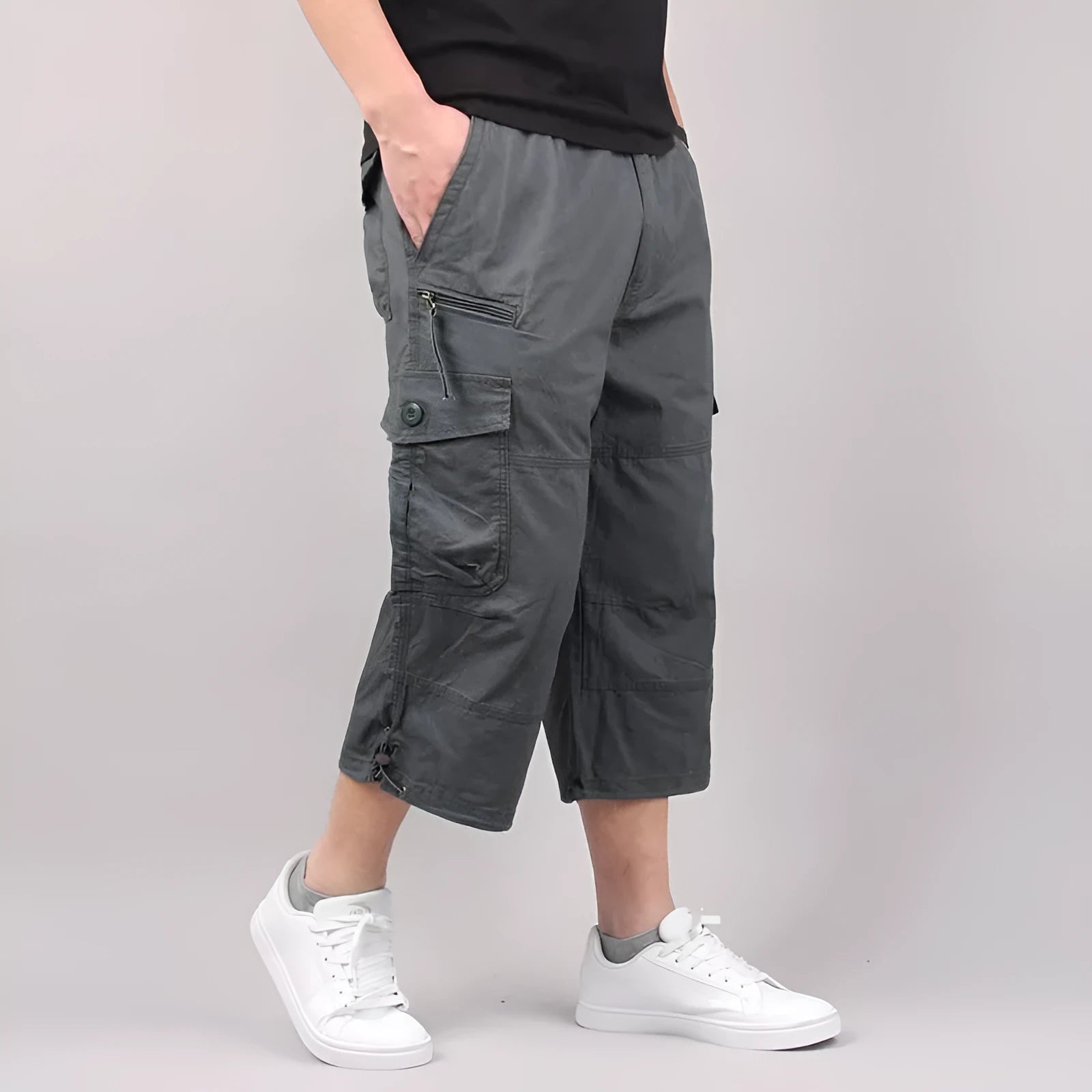 Men's loose fit cotton cropped pants in army green colour, shown on a hanger.