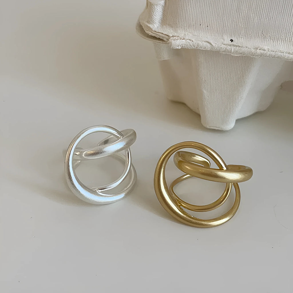 Geometric open ring with three-dimensional interlaced design in matte metal finish