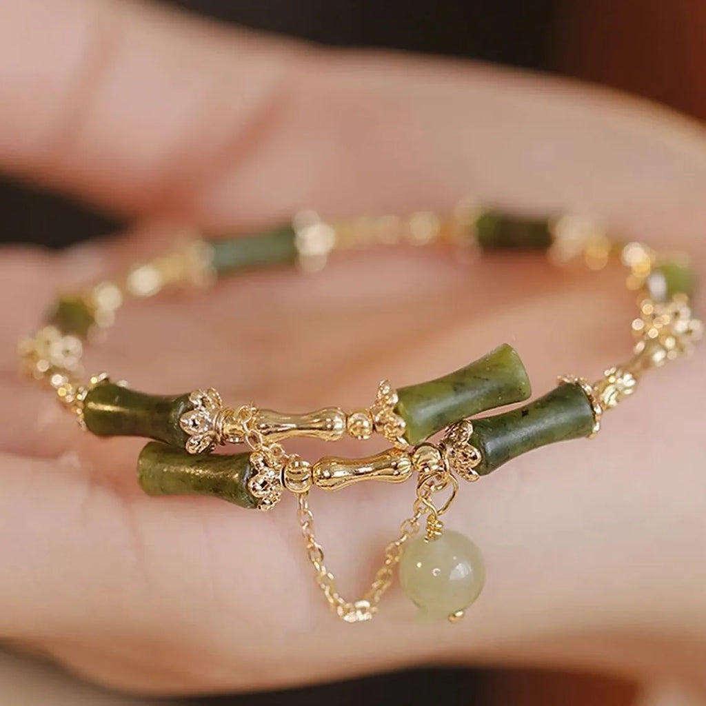 Women's bamboo beaded bracelet in plum wine colour with coloured glass and bamboo joint design.