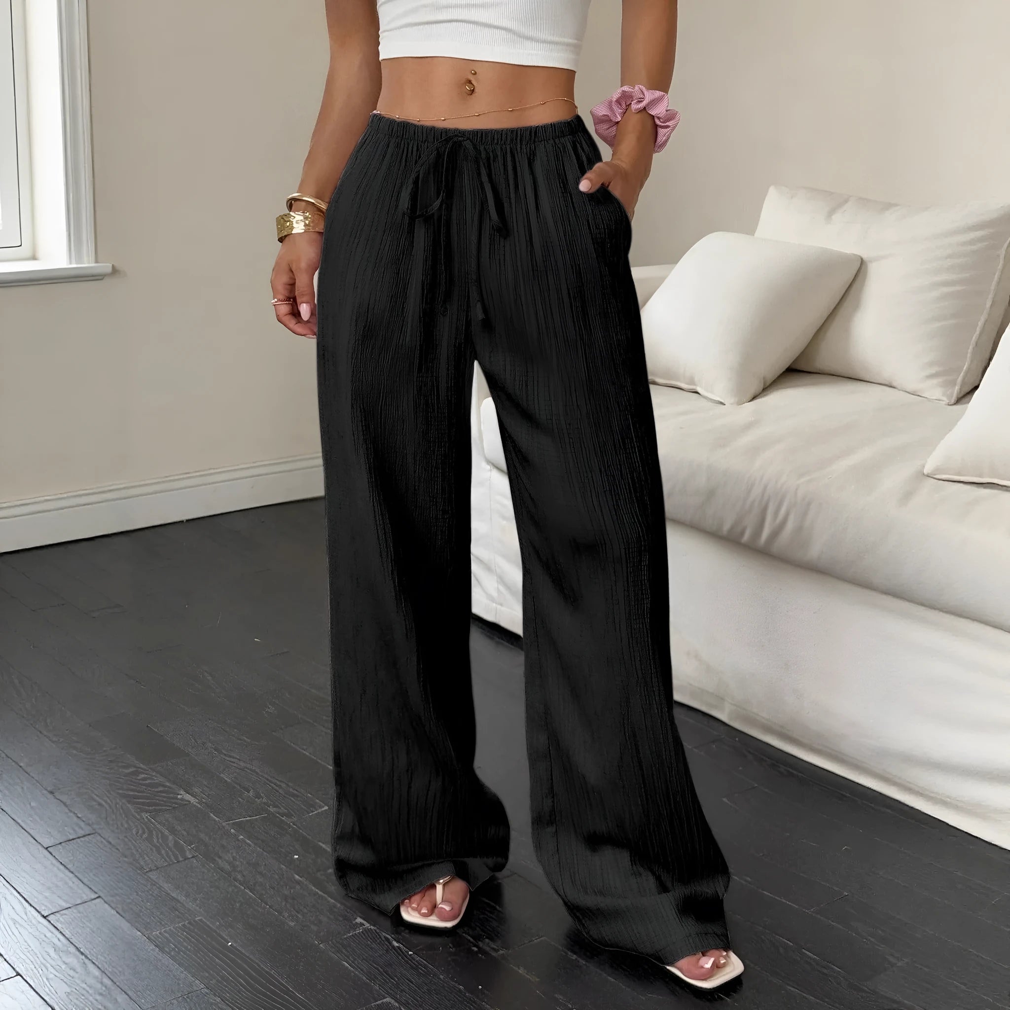 Women's black wide-leg trousers with lace-up waist trimming detail on mid-rise waist