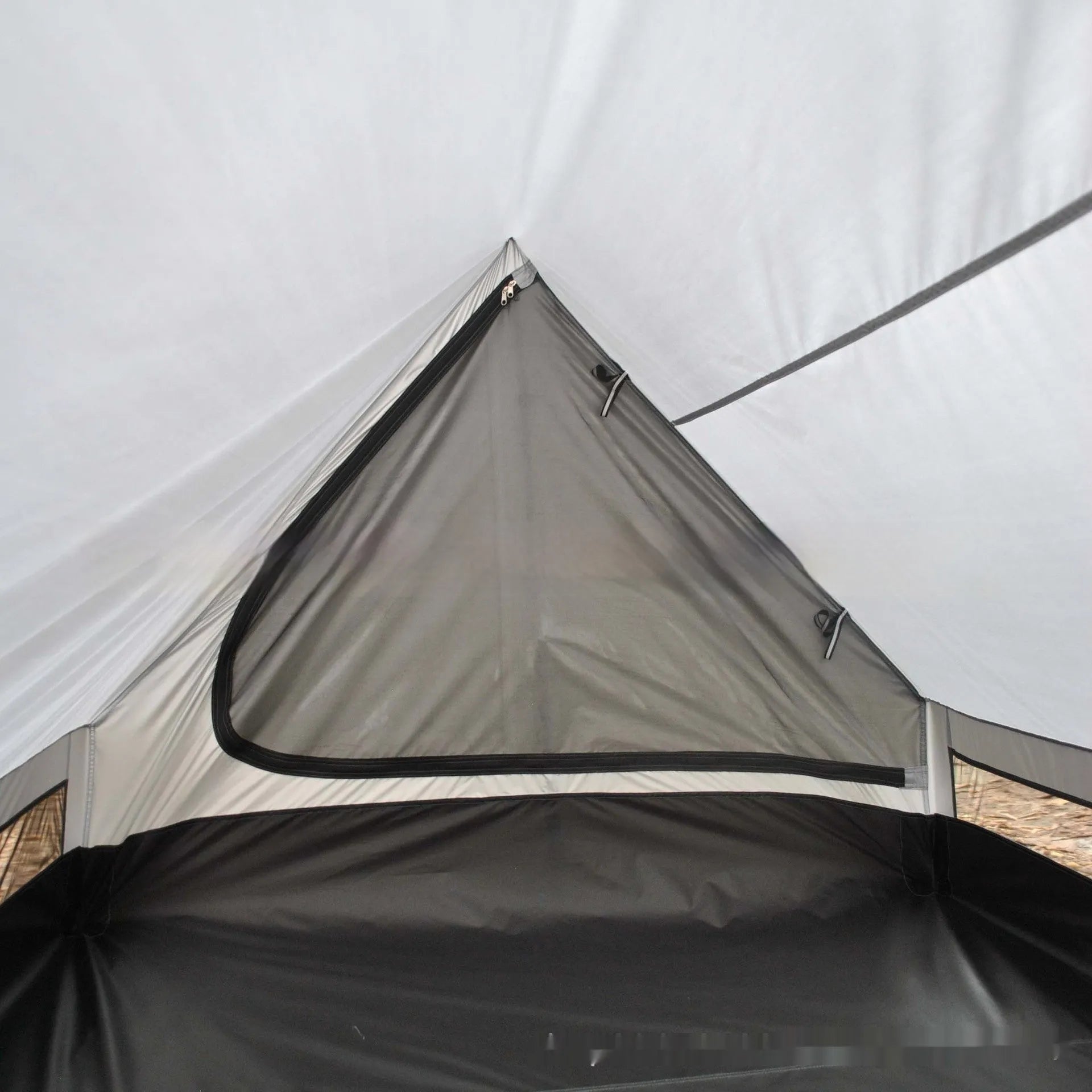 Brown or white A-line hiking tent pitched using hiking canes, showing spacious interior for 2-3 people.