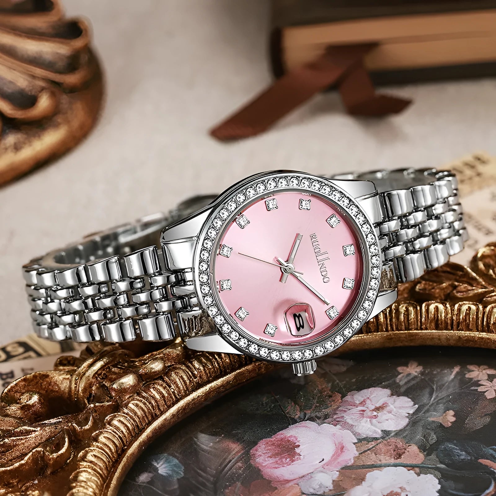 Women's silver calendar watch with circular dial showing date function and stainless steel buckle