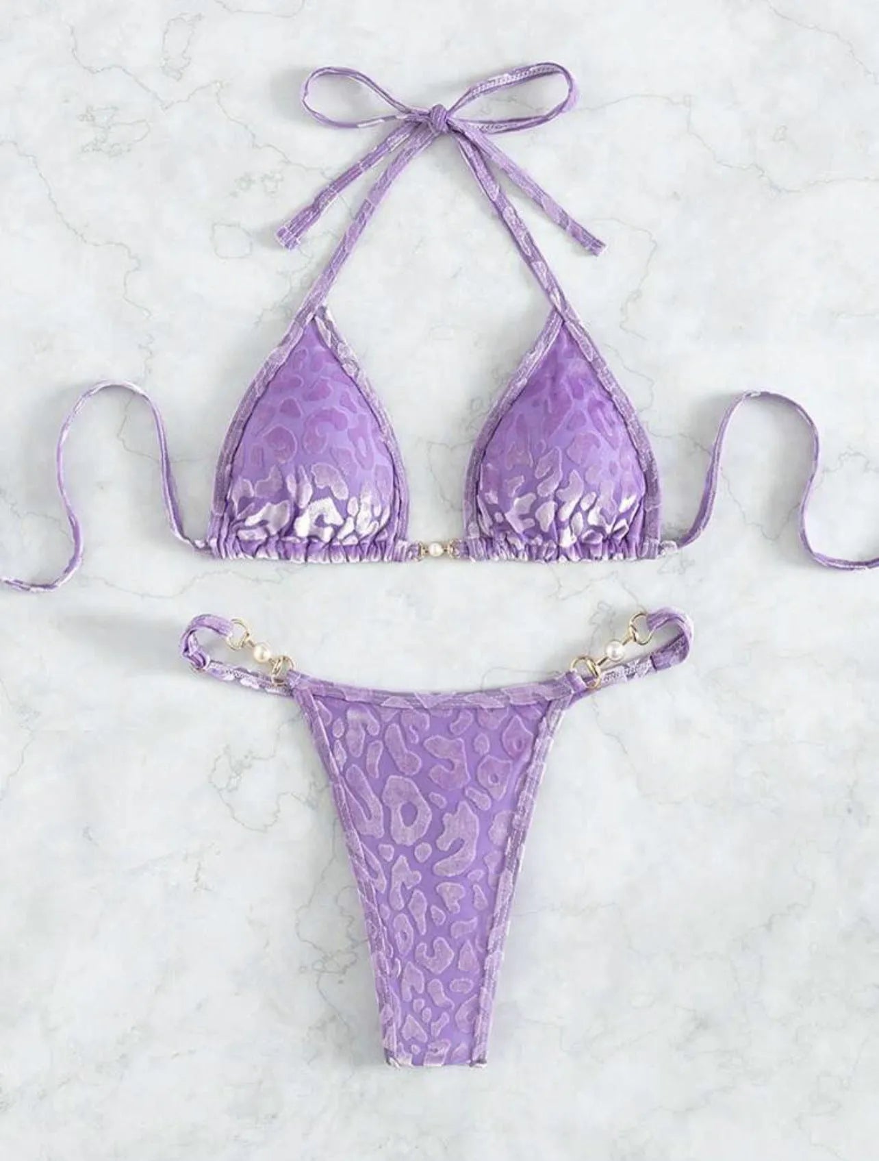 Women's blue leopard print T-shaped bikini swimsuit made from polyester and spandex fabric.