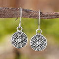 Geometric round women's earrings with distressed ethnic print in retro bohemian style.