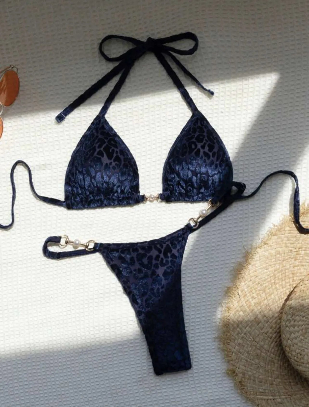 Women's blue leopard print T-shaped bikini swimsuit made from polyester and spandex fabric.