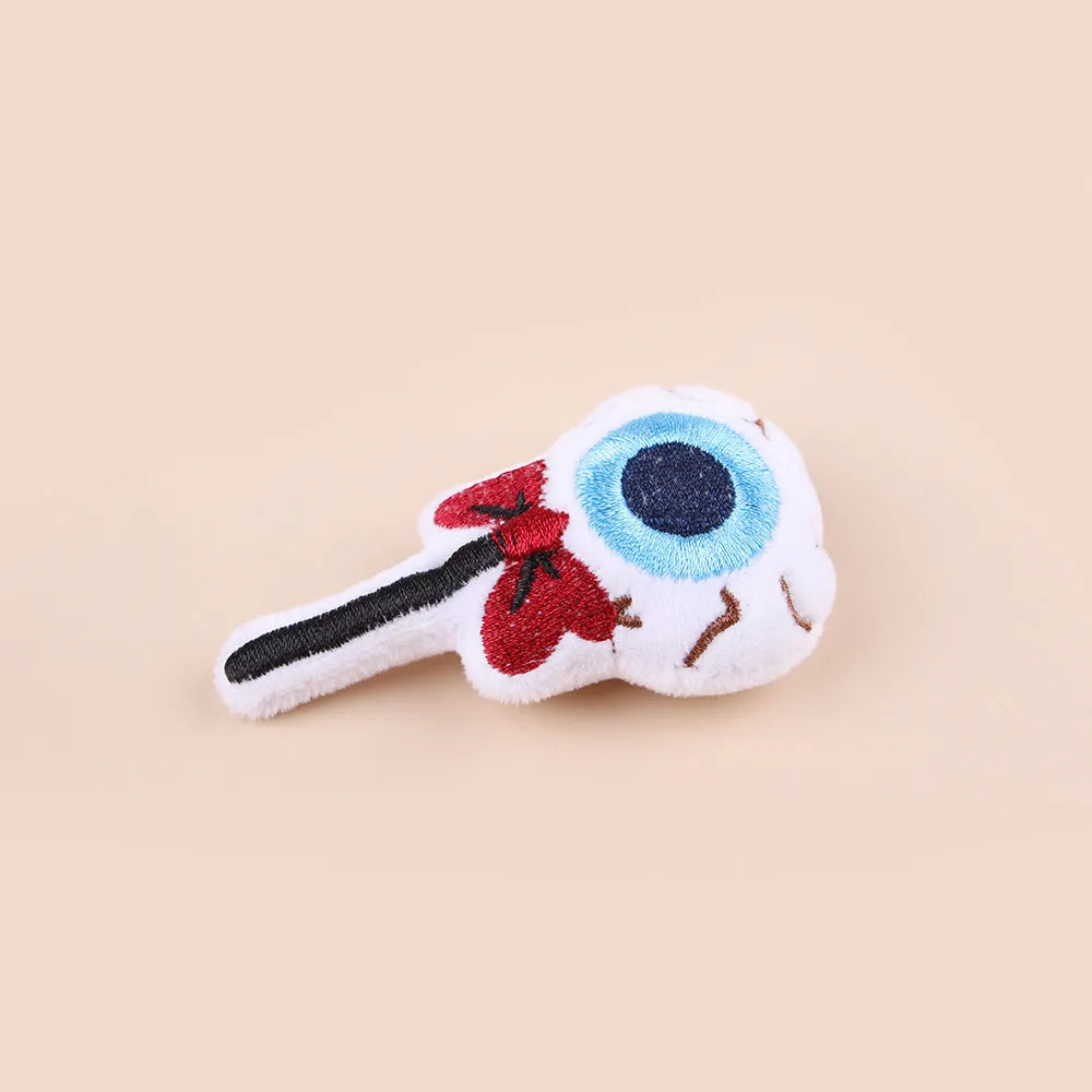 Plush cat teaser toy with three interchangeable heads: eyes, candy, and skull designs