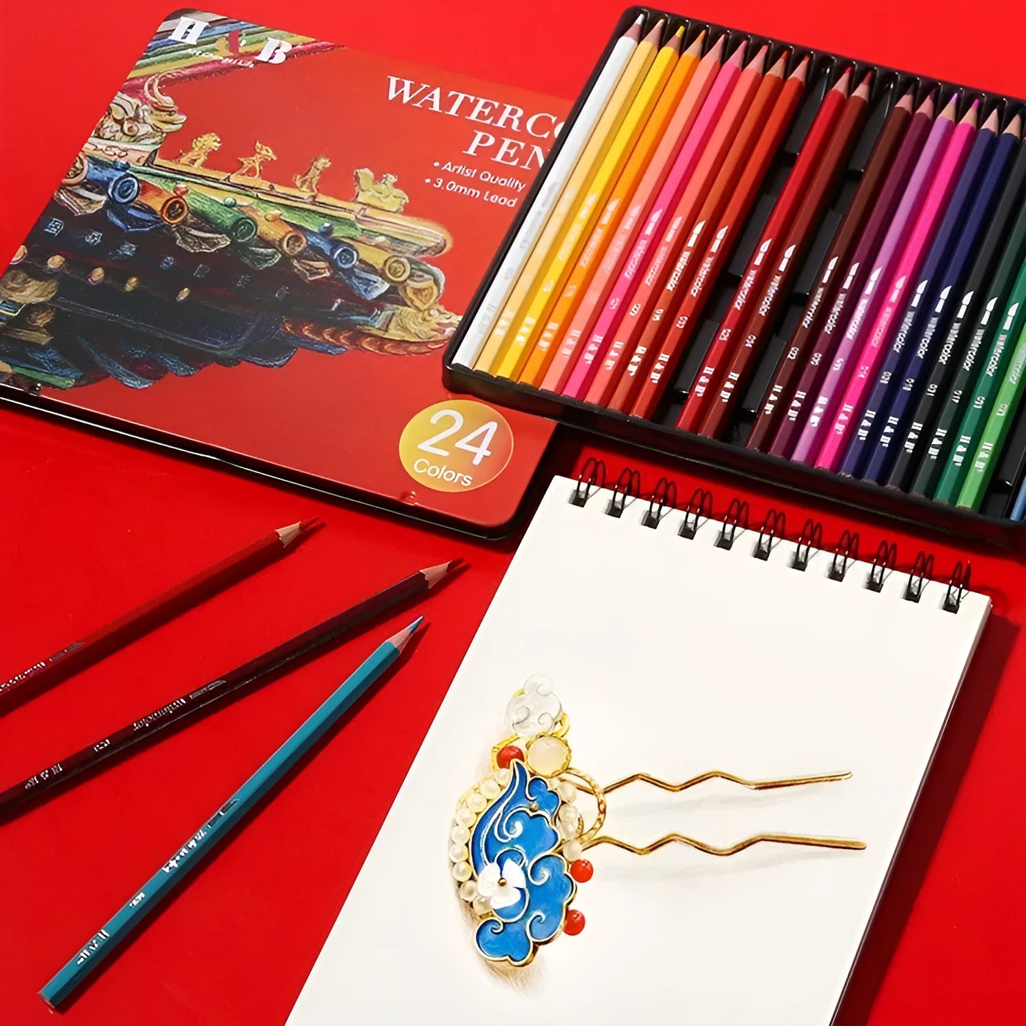 Open iron box showing 24 water-soluble coloured pencils and a brush for art projects