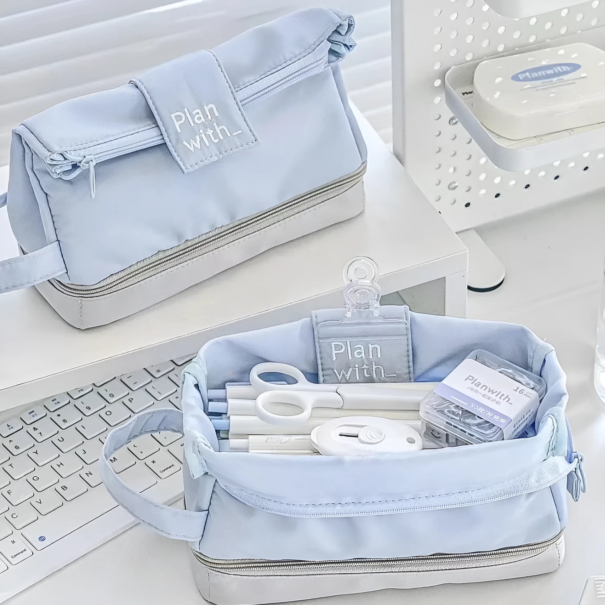 A dark blue folding double-layer pencil case made from polyester fabric, shown open to reveal internal dividers.