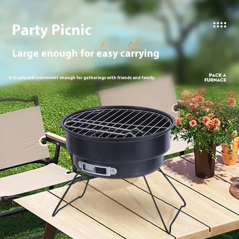 Small round metal camping stove with folding legs, mesh grill pan, charcoal clip, and carry bag.