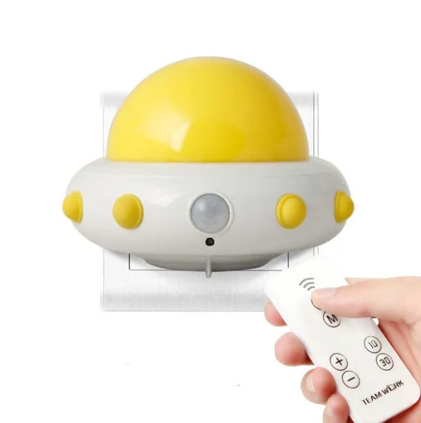 Remote control UFO shaped bedside night light in blue, pink, or white with cartoon design