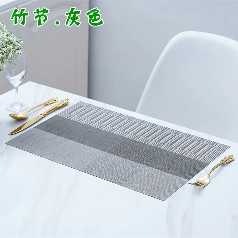 PVC non-slip dish mat in modern simple style on a dining table, showing gradient bamboo black colour option.