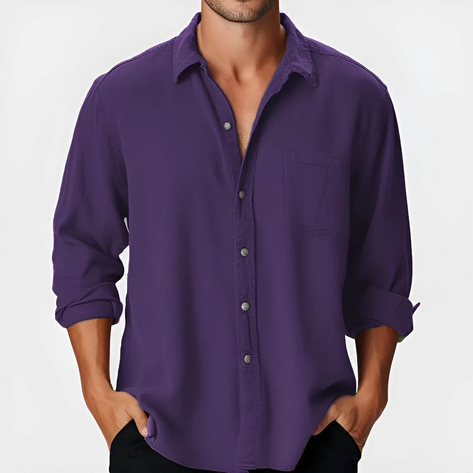 Man wearing a loose fit long sleeve beach shirt with a stand collar in a solid colour.