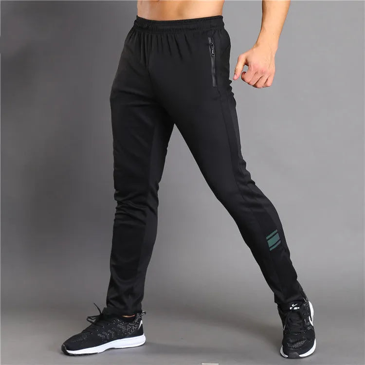 Slim-fit polyester running trousers with colour-changing reflective printing and zip pocket, black, front view