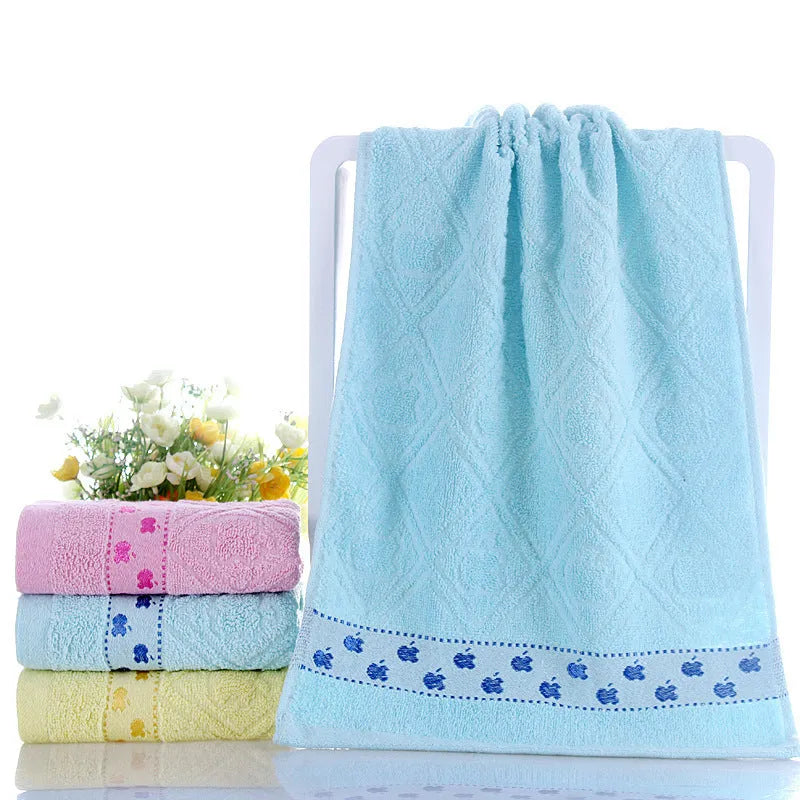 Cotton face towel 73x33cm in blue pink yellow patterns on hanger