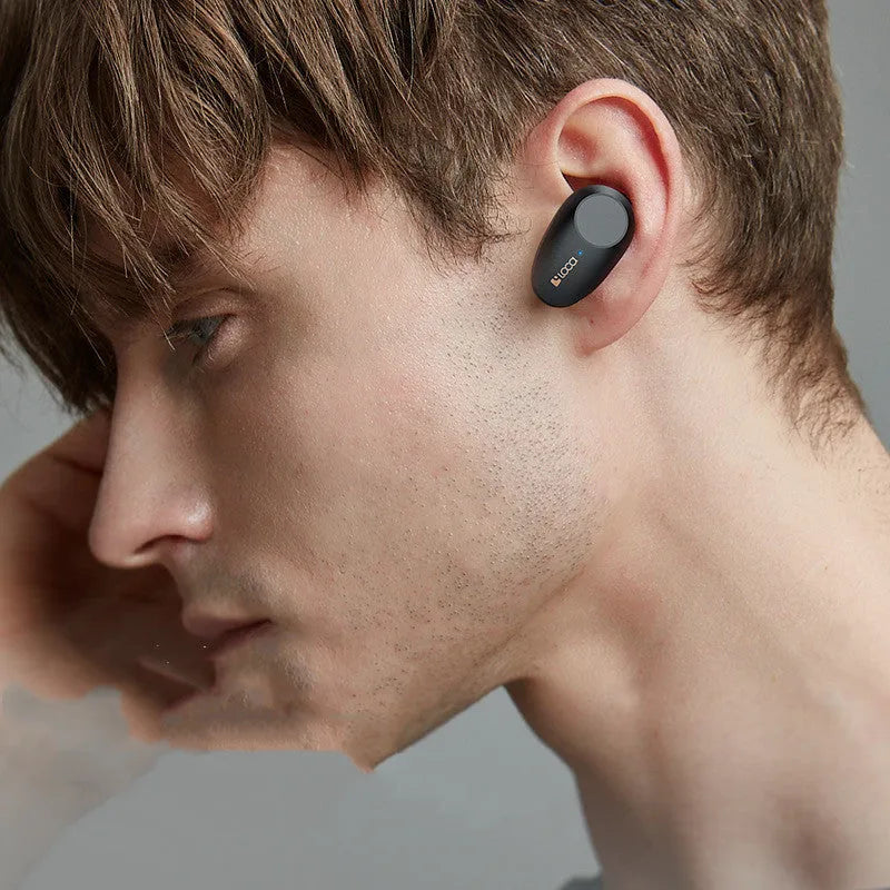 Black wireless Bluetooth stereo headset with charging stand