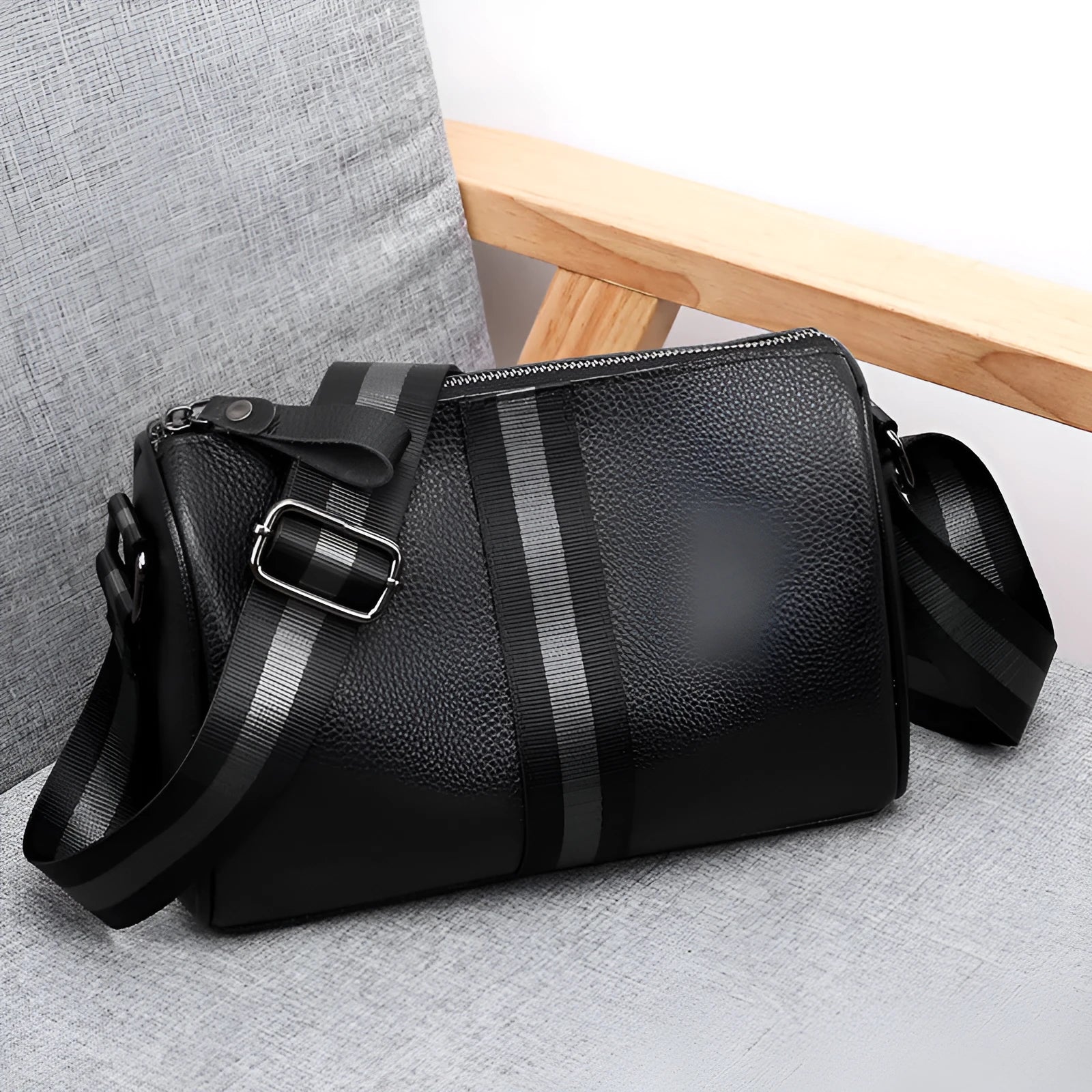Black genuine leather crossbody bag with dimensions 24cm wide by 16cm high by 13cm deep