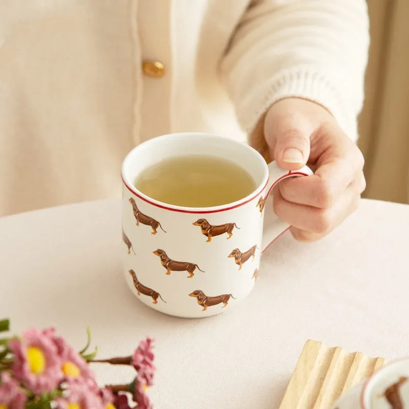 Ceramic sausage dog teapot mug cup and saucer three-piece set on table