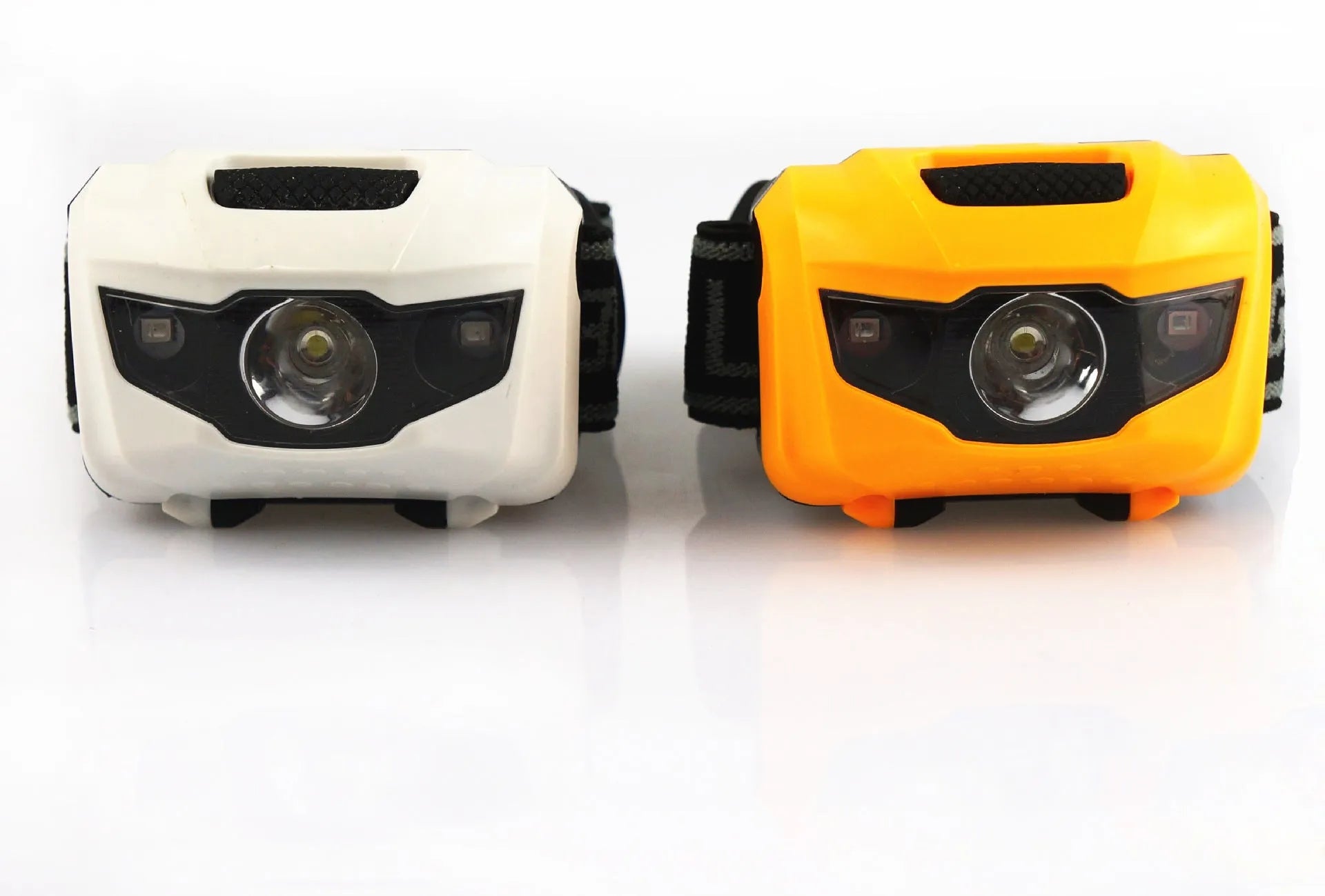 Black head torch with white and red LEDs mounted on an adjustable head strap for outdoor use.