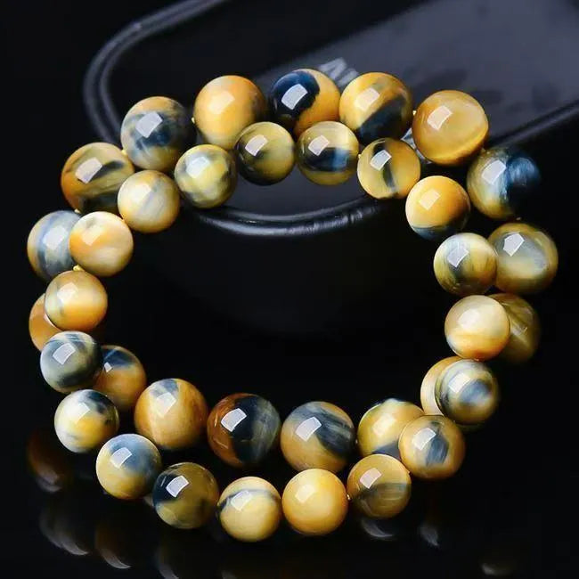 Fantasy Tigereye agate beaded bracelet with round geometric beads on a wrist, showing natural stone colour.