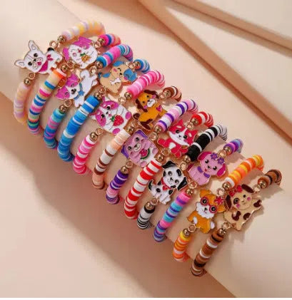 Children's polymer clay bracelet with dinosaur bead theme on a white background