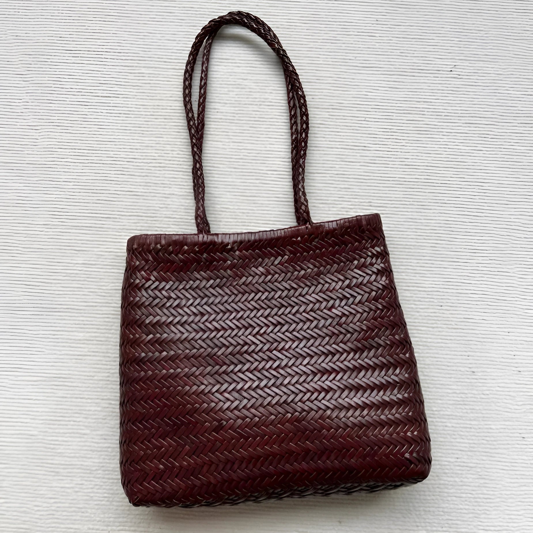 Brown woven cowhide leather shoulder bag with three-dimensional outer pocket