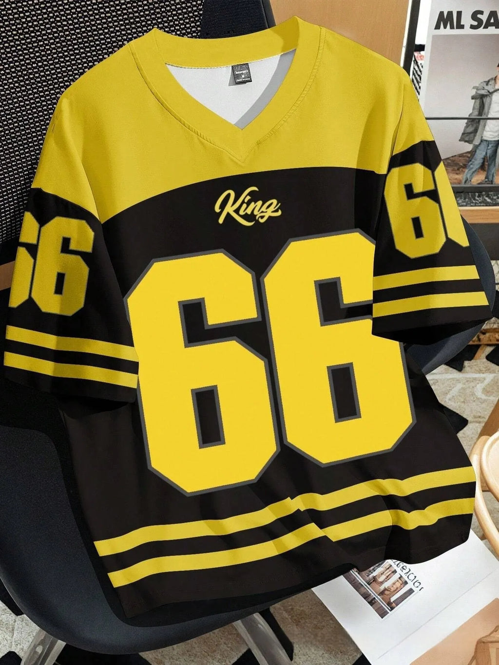 Man wearing a loose fit black t-shirt with a large, colourful 3D printed graphic of Chicago No 23 on the front.