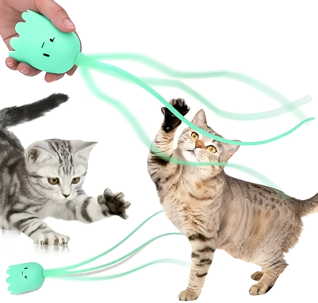 Green automatic cat toy with swinging silicone tails on a white surface
