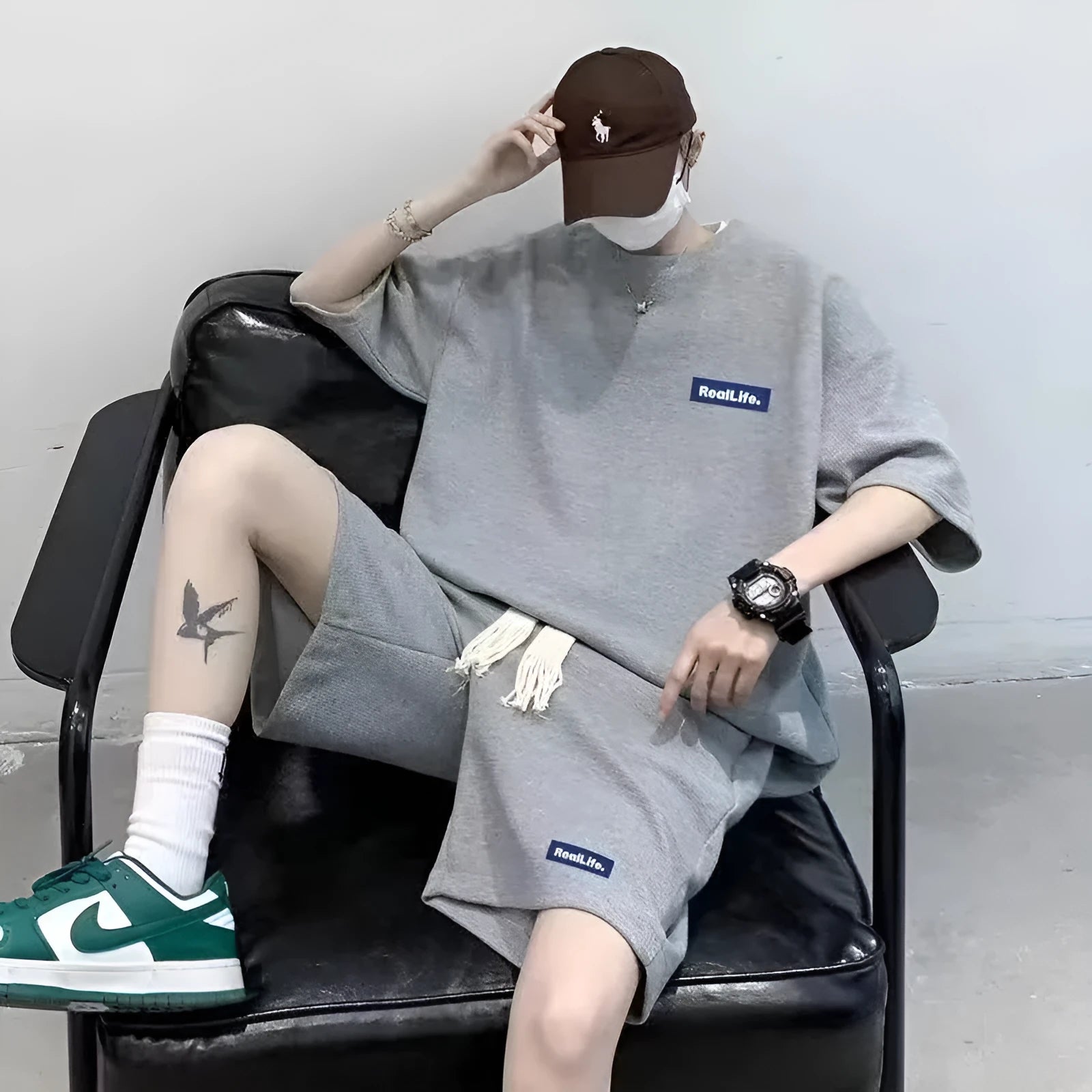 Man wearing a grey waffle-textured short sleeve top and matching shorts leisure set.