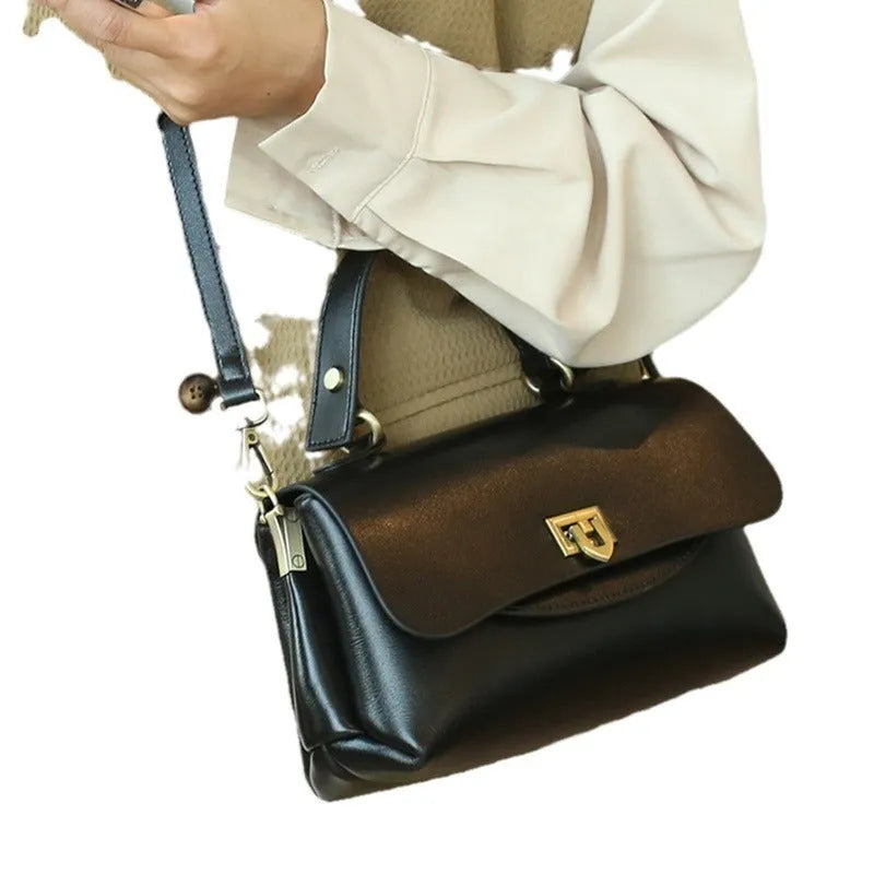 Women's dark brown genuine leather saddle back handbag with multiple compartments and shoulder straps