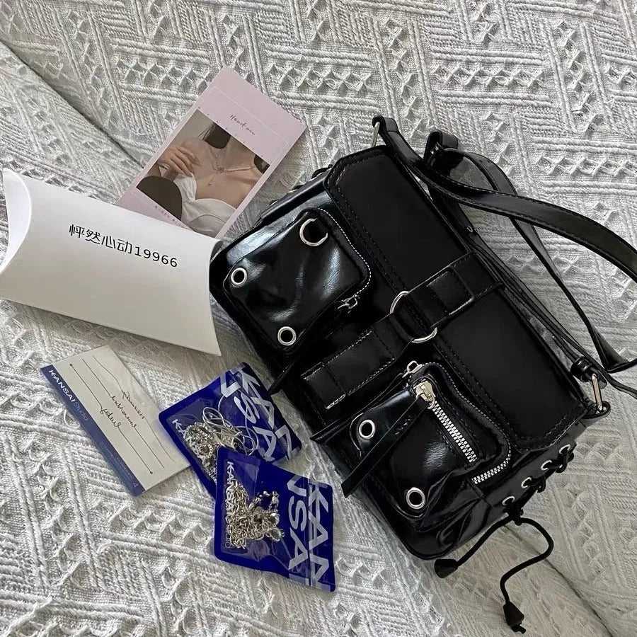 Black PU underarm baguette messenger bag with adjustable strap and zippered compartment