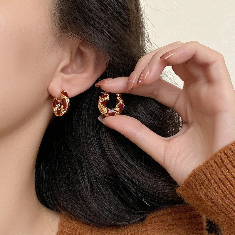 Gold plated alloy small hoop earrings with enamel colour in red, black, and white geometric shapes