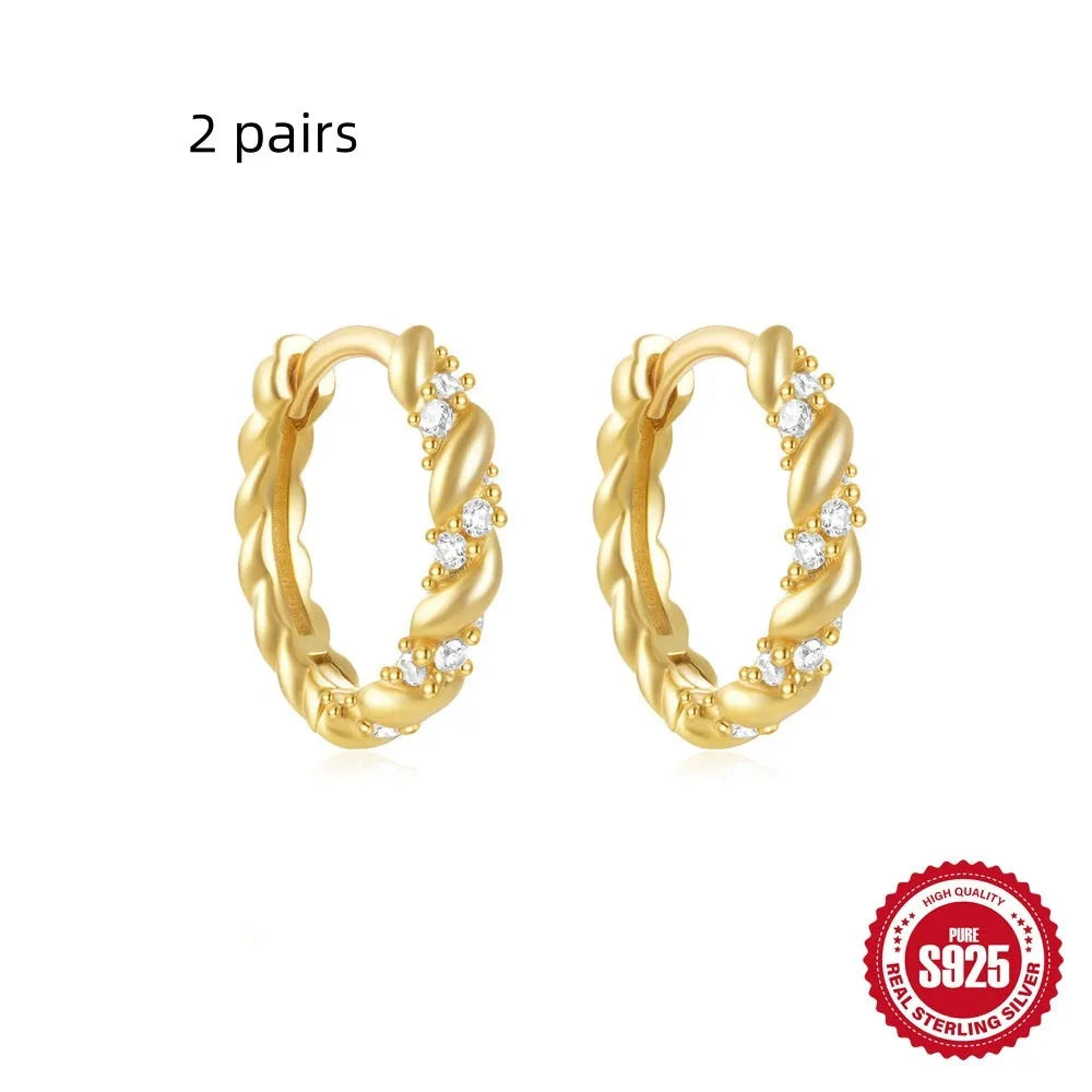 Small round geometric sterling silver stud earrings in gold and silver electroplated finishes.