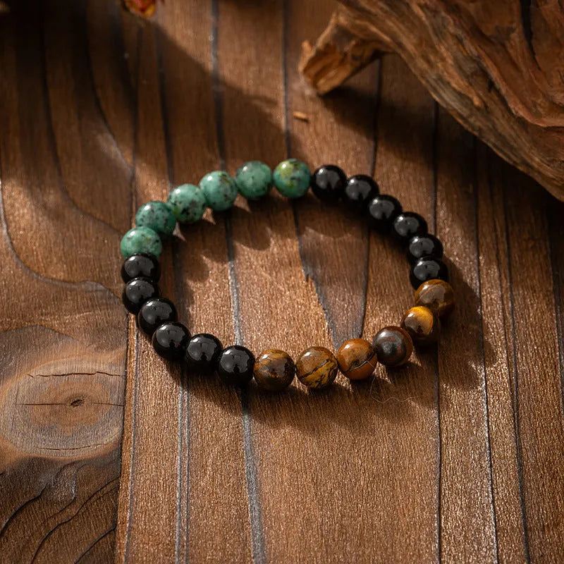 Vintage bohemian long necklace with geometric stone beads and tassel, shown with a matching shorter bracelet.