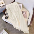 Women's loose black polyester blouse with regular sleeves on a hanger.