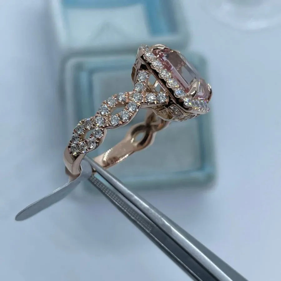 Rose gold geometric alloy ring on a plain background