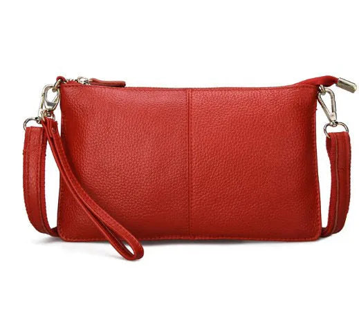 Structured cowhide lady slant bag in apricot colour with hand strap and shoulder strap, showing slim profile.