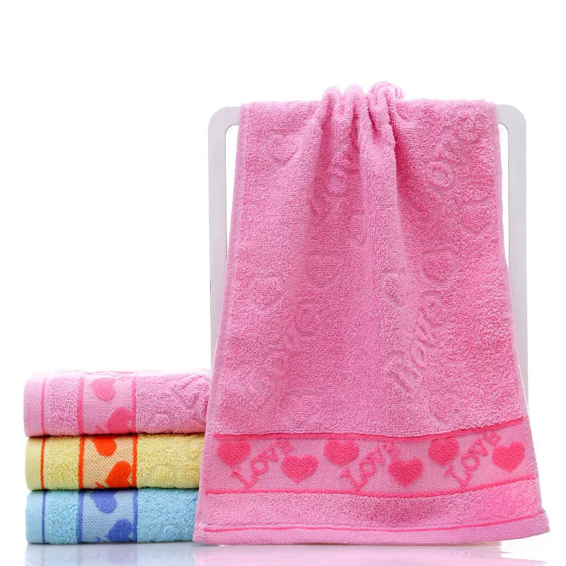 Cotton face towel 73x33cm in blue pink yellow patterns on hanger