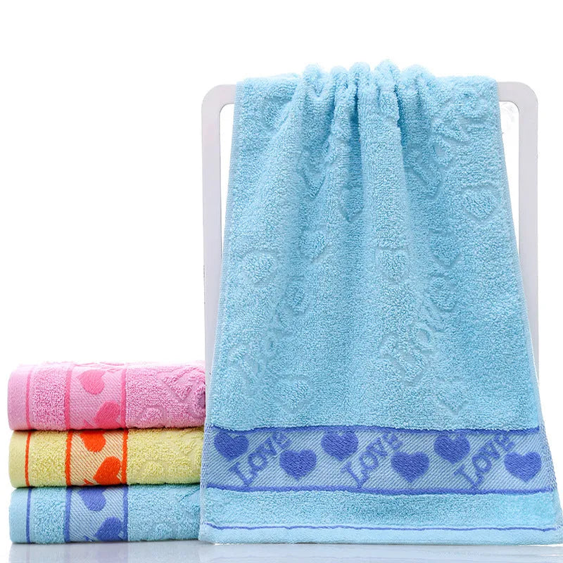 Cotton face towel 73x33cm in blue pink yellow patterns on hanger